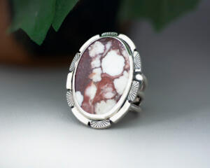 3/4 view facing left large oval wild horse magnesite gemstone silver statement ring, bezel set with stamped cutout wire accent